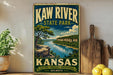 A vintage-style metal sign for Kaw River State Park in Kansas, featuring a scenic landscape with a river, trees, and mountains.