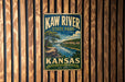 A vintage metal sign for Kaw River State Park in Kansas, featuring a scenic landscape with a river and mountains.
