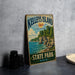 A vintage-style metal sign for Kelley's Island State Park in Ohio, featuring a scenic illustration of the lake and surrounding landscape.