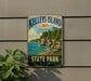 A vintage metal sign for Kelley's Island, Ohio's Lake Erie Gem State Park, featuring a scenic landscape with cliffs, water, and greenery.