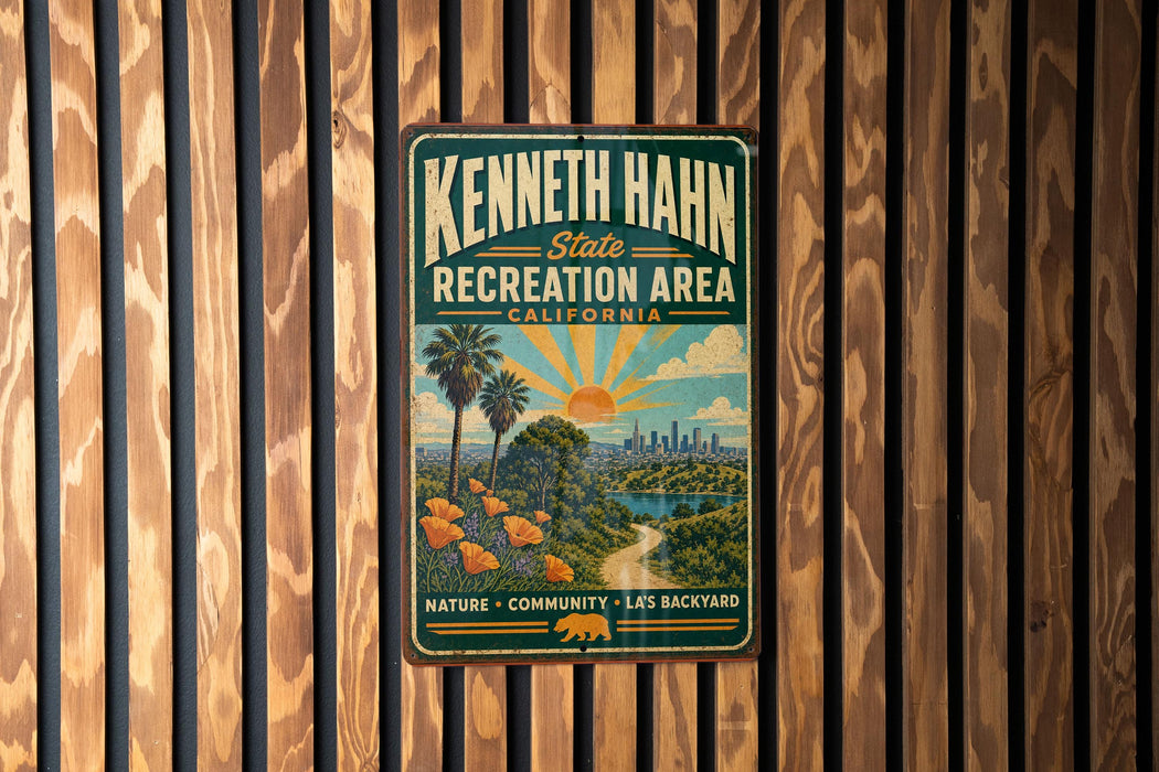 A vintage-style metal sign for the Kenneth Hahn State Recreation Area in California, featuring a scenic illustration of a beach, palm trees, and a city skyline.