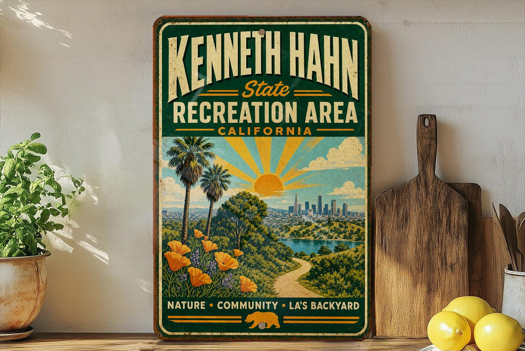 A vintage-style sign for the Kenneth Hahn State Recreation Area in California, featuring a scenic landscape with palm trees, a sun, and a city skyline.