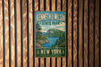 A vintage metal sign for Kenneth L. Wilson State Park in New York, featuring a scenic landscape with a lake and mountains.