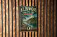 A vintage metal sign for Kilen Woods State Park in Minnesota, featuring a scenic landscape with a lake and forest.
