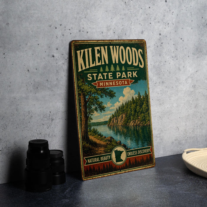 A vintage-style metal sign for Kilen Woods State Park in Minnesota, featuring a scenic landscape with a lake and forest.