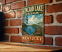 A vintage-style sign for Kincaid Lake State Park in Kentucky, featuring a scenic image of the lake and surrounding landscape.