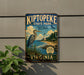 A vintage-style metal sign for Kiptopek State Park, featuring a large heron and a lighthouse, is displayed on a wall next to a plant.