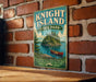 A vintage-style metal sign for Knight Island State Park in Vermont, featuring a scenic illustration of a lake, island, and canoe.