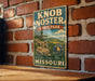 A vintage metal sign for Knob Noster State Park in Missouri, featuring a scenic landscape with mountains and a river.
