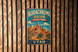 A vintage-style metal sign for Kodachrome Basin State Park in Utah, featuring a scenic illustration of the basin and mountains.