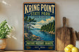 A vintage-style sign for Kring Point State Park in New York, featuring a scenic landscape with pine trees, a lake, and mountains.