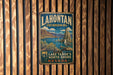 A vintage metal sign for Lake Tahoe, Nevada, hanging on a wooden wall.