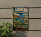 A vintage-style metal sign for Lake Tahoe, Nevada, featuring a scenic landscape with mountains, a lake, and a seagull.