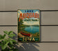 A vintage-style sign for Lake Ahwatukee State Park in Iowa, featuring a scenic image of a lake, a canoe, and a sailboat.