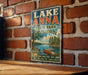 A vintage-style metal sign for Lake Anna State Park in Virginia, featuring a scenic illustration of a lake, trees, and a boat.