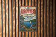 A vintage-style metal sign for Lake Arrowhead State Park in Texas, featuring a scenic landscape with a lake, mountains, and a sailboat.