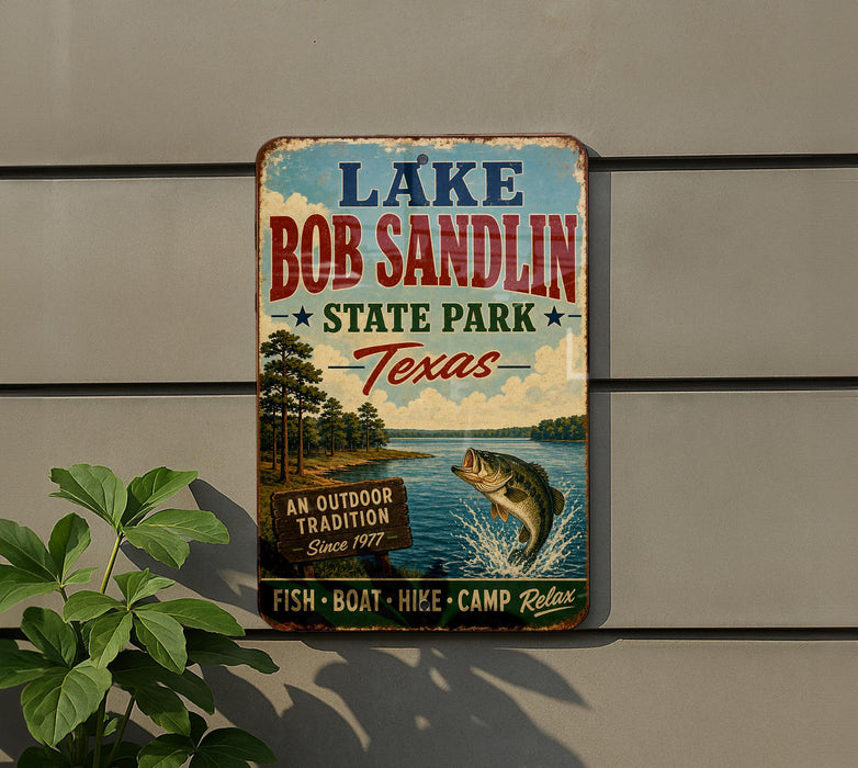 A vintage-style sign for Lake Bob Sandlin State Park in Texas, featuring a fish jumping out of the water and surrounded by trees.