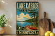 A vintage-style sign for Lake Carlos State Park in Minnesota, featuring a canoe on a lake surrounded by pine trees.