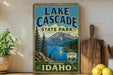 A vintage-style sign for Lake Cascade State Park in Idaho, featuring a scenic mountain landscape and a lake.