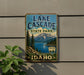 A vintage-style metal sign for Lake Cascade State Park in Idaho, featuring a scenic mountain landscape and a lake.