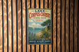 A vintage metal sign for LakeCorp Christi State Park in Texas, featuring a scenic landscape with a lake, palm trees, and a sailboat.