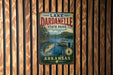 A vintage metal sign for Lake Dardanelle State Park in Arkansas, featuring a scenic illustration of a lake, mountains, and boats.
