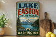 A vintage-style sign for Lake Easton State Park in Washington, featuring a scenic mountain landscape and a lake.