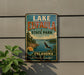 A vintage-style sign for Lake Eufaula State Park in Oklahoma, featuring a scenic landscape with a lake, mountains, and a bald eagle in flight.