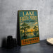 A vintage-style sign for Lake Fausse Pointe State Park in Louisiana, featuring a scenic illustration of a bay with trees and a bird.