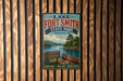 A vintage-style metal sign for Lake Fort Smith State Park in Arkansas, featuring a scenic image of a lake, canoe, and mountains.