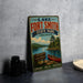 A vintage-style metal sign for Lake Fort Smith State Park in Arkansas, featuring a scenic illustration of a lake, canoe, and surrounding landscape.