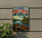 A vintage-style sign for Lake Fort Smith State Park in Arkansas, featuring a scenic image of a lake, a canoe, and a forested shoreline.