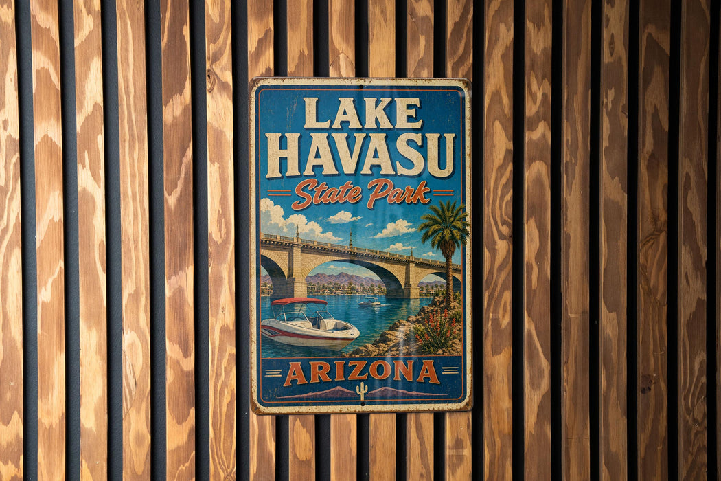 A vintage metal sign for Lake Havasu State Park in Arizona, featuring a scenic illustration of a bridge and a boat on the water.