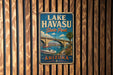 A vintage metal sign for Lake Havasu State Park in Arizona, featuring a scenic illustration of a bridge and a boat on the water.