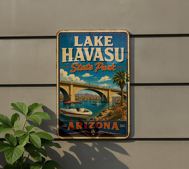 A vintage-style sign for Lake Havasu State Park in Arizona, featuring a scenic illustration of a bridge, palm trees, and a boat on the water.