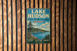 A vintage metal sign for Lake Hudson State Recreation Area in Michigan, featuring a scenic landscape with a lake, mountains, and pine trees.
