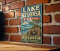 A vintage-style sign for Lake Kegona State Park in Wisconsin, featuring a scenic illustration of the park's lake and surrounding landscape.