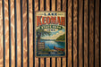 A vintage-style metal sign for Lake Keomah State Park in Iowa, featuring a scenic image of the lake and surrounding landscape.