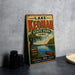 A vintage-style metal sign for Lake Keomah State Park in Iowa, featuring a scenic illustration of the lake and surrounding landscape.