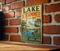 A vintage-style sign for Lake Kissimmee State Park in Florida, featuring a scenic illustration of a lake, palm trees, and a bird.