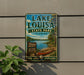 A vintage-style metal sign for Lake Louisa State Park in Florida, featuring a scenic image of a lake, canoe, and surrounding nature.