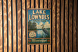 A vintage-style metal sign for Lake Lowndes State Park in Mississippi, featuring a scenic illustration of a bird and a lake.