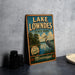 A vintage-style sign for Lake Lowndes State Park in Mississippi, featuring an illustration of a heron and a lake surrounded by trees.