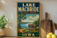 A vintage-style sign for Lake Macbride State Park in Iowa, featuring a scenic landscape with a lake, trees, and a path leading to the park entrance.