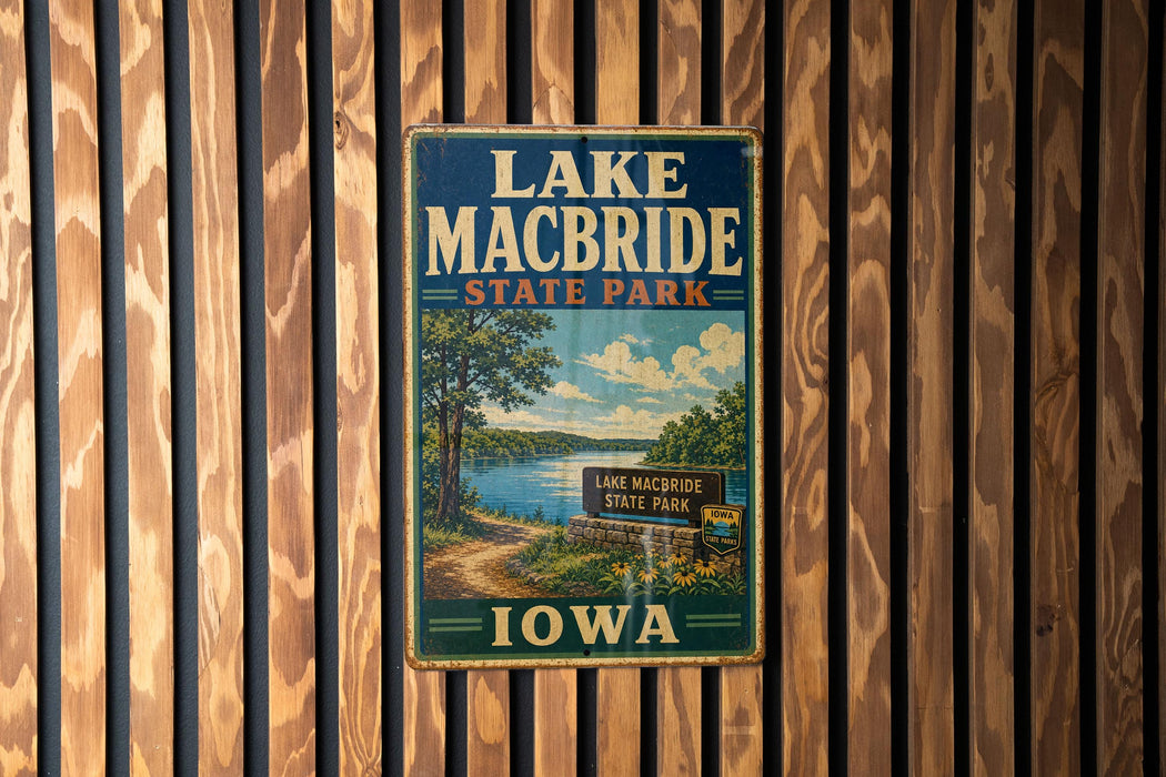 A vintage metal sign for Lake Macbride State Park in Iowa, featuring a scenic illustration of the park's landscape.