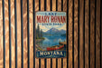 A vintage metal sign for Lake Mary Ronan State Park in Montana, featuring a scenic image of a lake, mountains, and a red canoe.