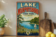 A vintage-style sign for Lake Murphysboro State Park in Illinois, featuring a scenic image of a lake, trees, and a sailboat.
