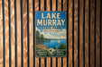A vintage metal sign for Lake Murray State Park in Oklahoma, featuring a scenic image of a lake and a sailboat.