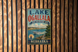 A vintage-style sign for Lake Ogallala, a state recreation area in Nebraska, is displayed on a wooden wall.