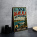 A vintage-style metal sign for Lake Ogallala, a state recreation area in Nebraska, featuring a scenic image of a boat on the lake.